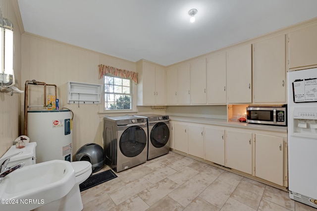 washroom featuring washing machine and clothes dryer, water heater, ornamental molding, and sink