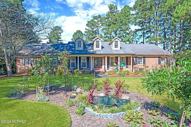 cape cod home with a front lawn