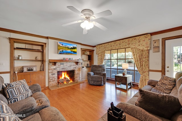 living room featuring a fireplace, plenty of natural light, light hardwood / wood-style flooring, and ceiling fan