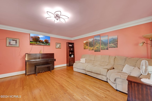 living room with crown molding and light hardwood / wood-style floors