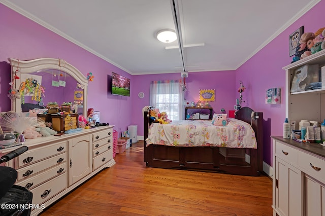 bedroom featuring crown molding and light hardwood / wood-style floors