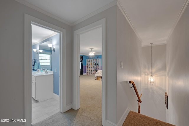 hallway featuring light carpet, crown molding, and sink