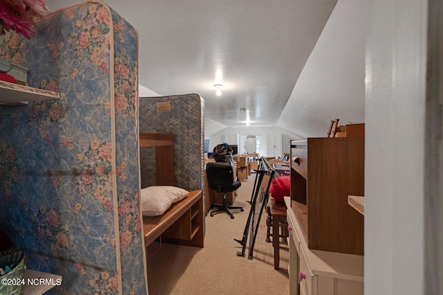 bedroom with carpet floors and lofted ceiling