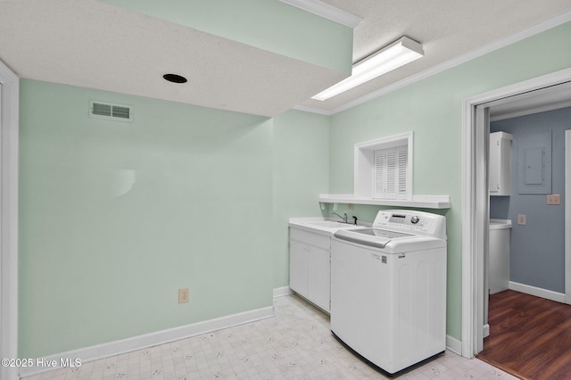 laundry area with sink, cabinets, washer / clothes dryer, a textured ceiling, and ornamental molding