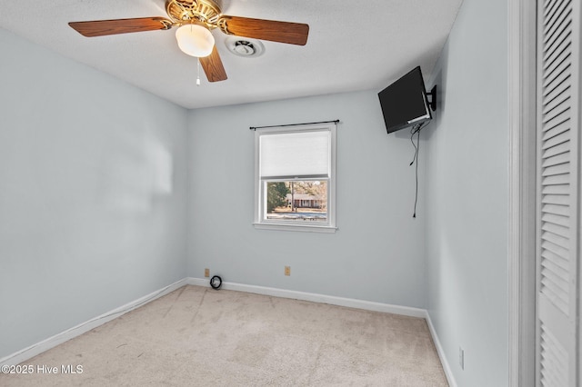 empty room featuring light carpet and ceiling fan