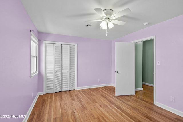 unfurnished bedroom with ceiling fan, a closet, and light hardwood / wood-style flooring