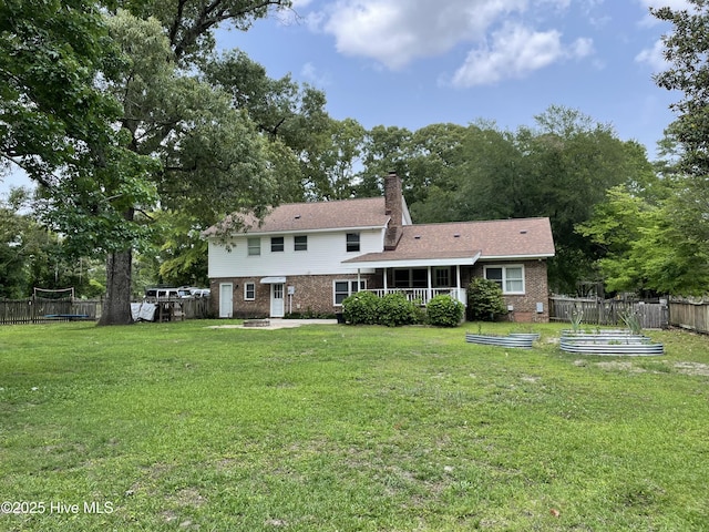 217 Randomwood Ln, River Bend, NC 28562 - rear view of property with brick siding, a vegetable garden, and a chimney