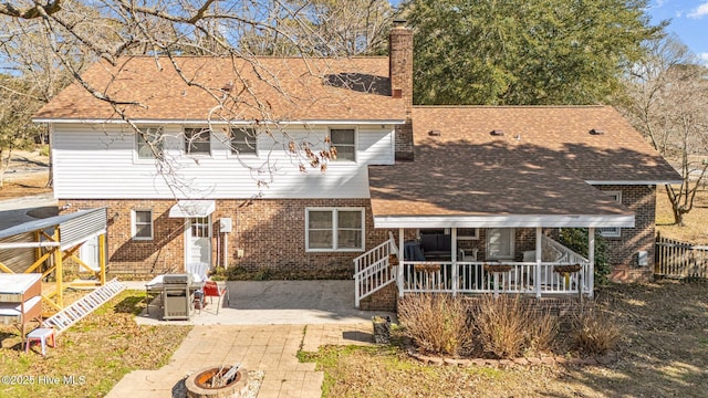 view of front of property with a fire pit and a patio area