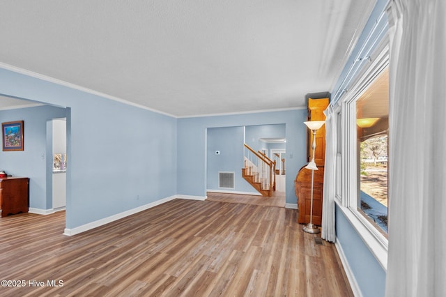 living room featuring light wood-type flooring and crown molding