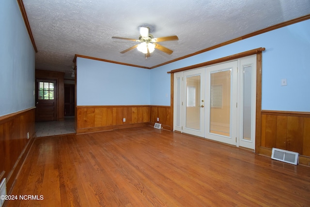 spare room with ceiling fan, hardwood / wood-style flooring, and crown molding