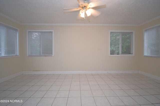 tiled empty room featuring a textured ceiling, ceiling fan, and crown molding