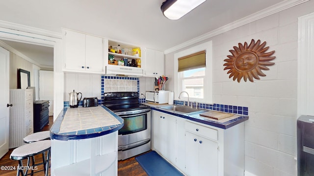 kitchen with white cabinetry, tile countertops, and stainless steel electric stove