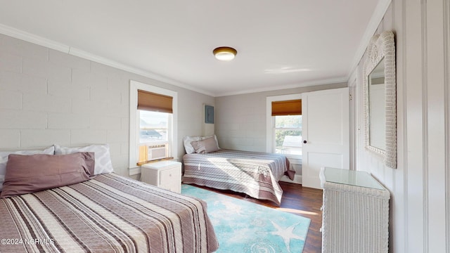 bedroom featuring ornamental molding, multiple windows, and dark wood-type flooring