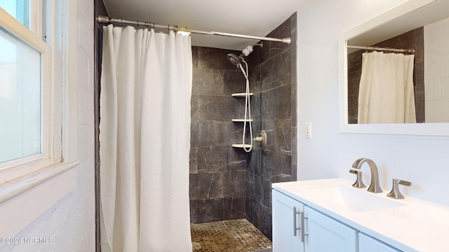 bathroom featuring a wealth of natural light, a shower with curtain, and vanity