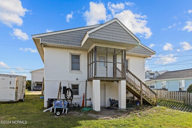 rear view of property with a yard