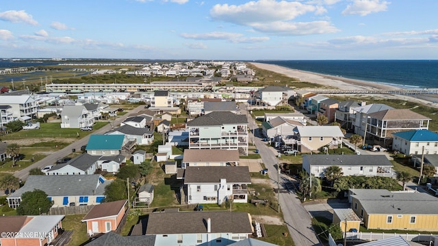 aerial view with a water view and a beach view