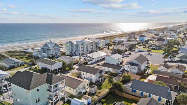 birds eye view of property with a view of the beach and a water view