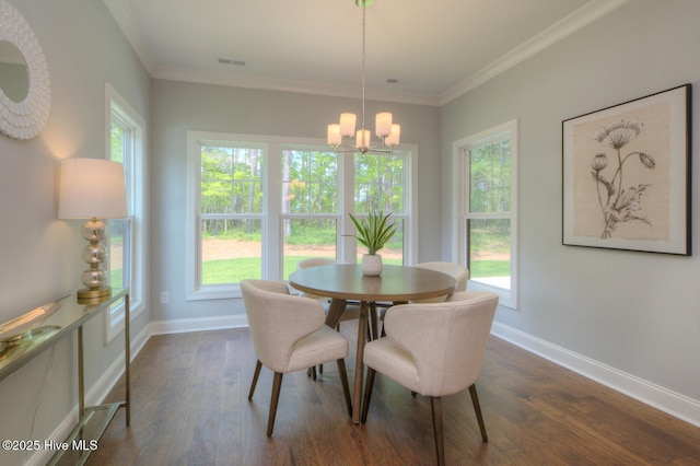 572 Hearthside Dr SE, Bolivia, NC 28422 - dining area featuring a chandelier, dark wood-type flooring, baseboards, and crown molding