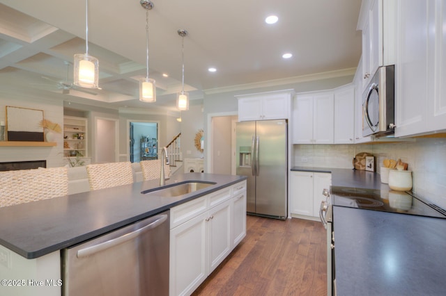 572 Hearthside Dr SE, Bolivia, NC 28422 - kitchen with stainless steel appliances, a sink, dark countertops, crown molding, and recessed lighting