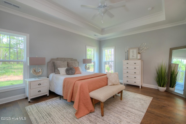 572 Hearthside Dr SE, Bolivia, NC 28422 - bedroom featuring a tray ceiling, dark wood-type flooring, baseboards, ornamental molding, and a ceiling fan