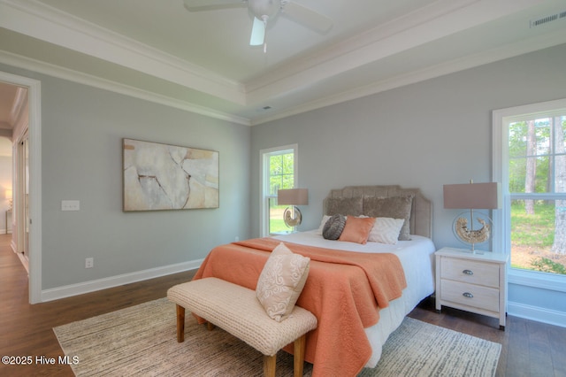572 Hearthside Dr SE, Bolivia, NC 28422 - bedroom with dark wood-style flooring, baseboards, crown molding, a tray ceiling, and a ceiling fan