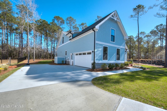 572 Hearthside Dr SE, Bolivia, NC 28422 - view of property exterior with central air condition unit, a garage, and concrete driveway
