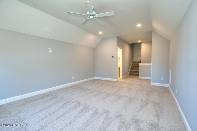 572 Hearthside Dr SE, Bolivia, NC 28422 - unfurnished living room featuring a ceiling fan, vaulted ceiling, light carpet, baseboards, and stairway