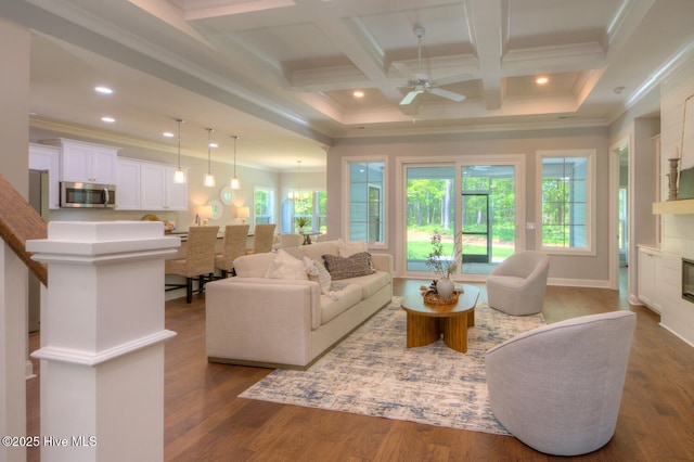 572 Hearthside Dr SE, Bolivia, NC 28422 - living room featuring a ceiling fan, crown molding, a glass covered fireplace, dark wood-type flooring, and beamed ceiling
