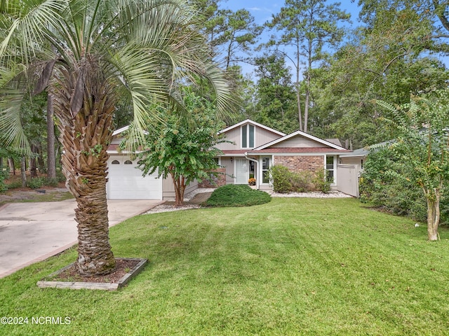 view of front of house with a garage and a front yard