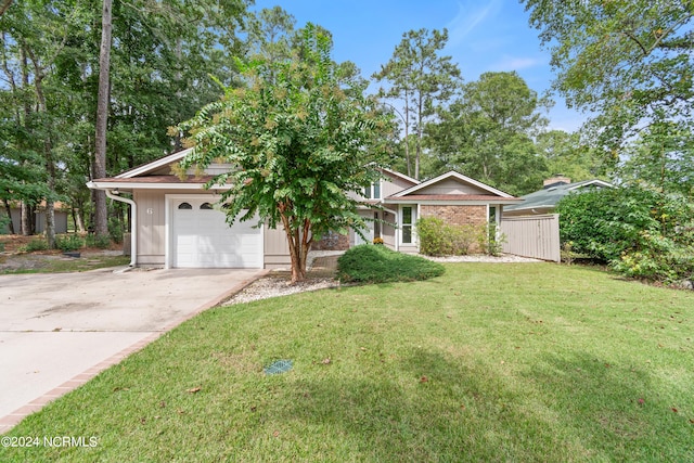 view of front of property with a garage and a front lawn