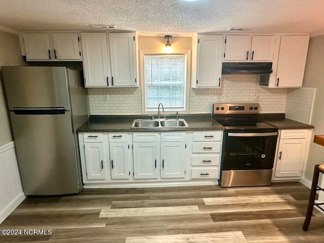 kitchen featuring white cabinetry, light hardwood / wood-style floors, appliances with stainless steel finishes, and sink