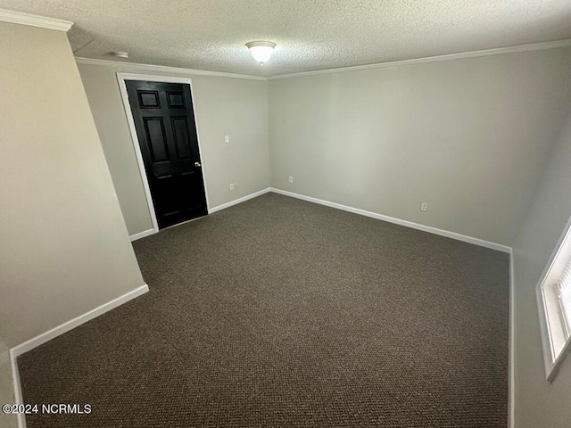 carpeted spare room featuring a textured ceiling and crown molding