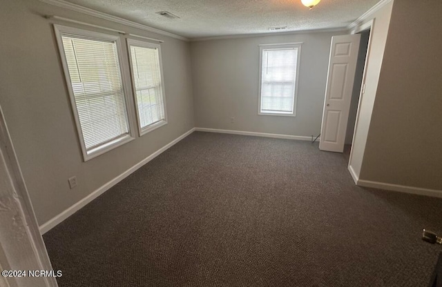 carpeted empty room with a textured ceiling and crown molding