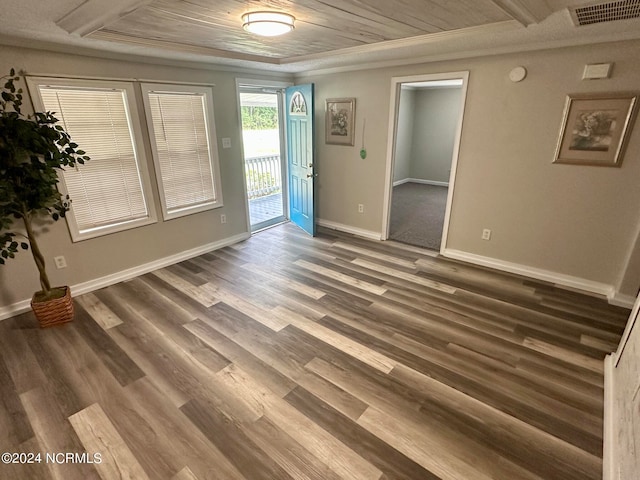 spare room with wood ceiling, dark hardwood / wood-style floors, and crown molding