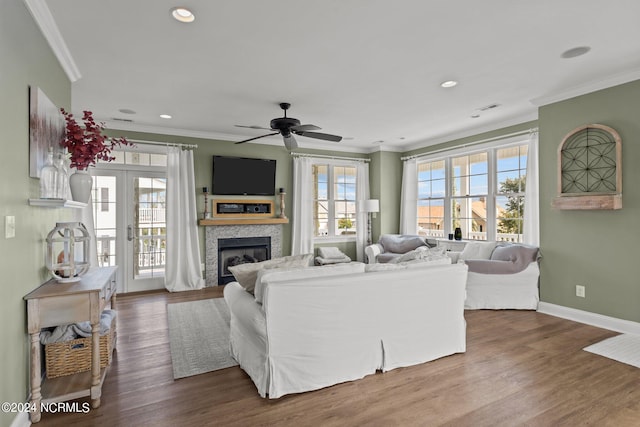 living room with ornamental molding, hardwood / wood-style flooring, and ceiling fan