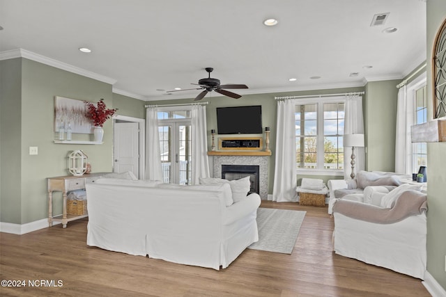 living room with ornamental molding, hardwood / wood-style flooring, and ceiling fan