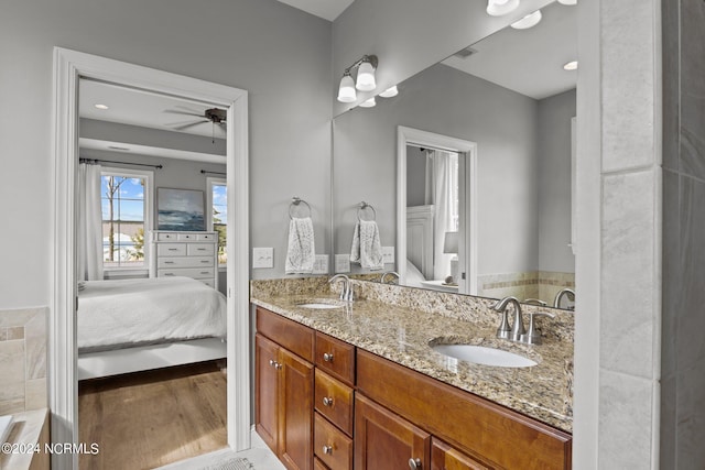 bathroom featuring ceiling fan, vanity, and wood-type flooring