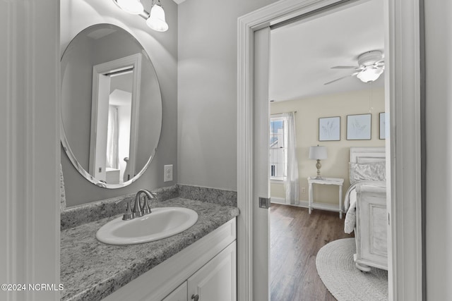 bathroom featuring vanity, hardwood / wood-style flooring, and ceiling fan