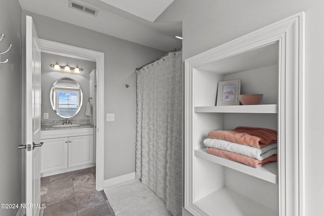 bathroom featuring curtained shower and vanity