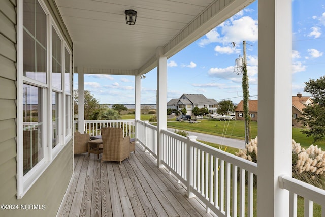 wooden terrace featuring a porch and a residential view