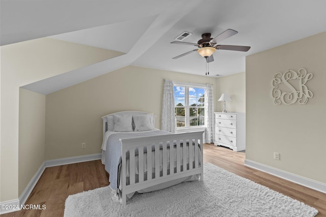 bedroom featuring lofted ceiling, wood-type flooring, and ceiling fan