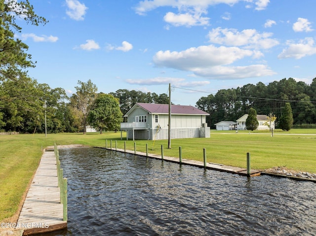 dock area featuring a yard and a water view