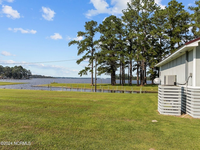 view of yard featuring a water view and central air condition unit