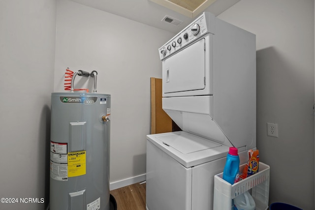 laundry room with stacked washer / drying machine, dark hardwood / wood-style floors, and electric water heater