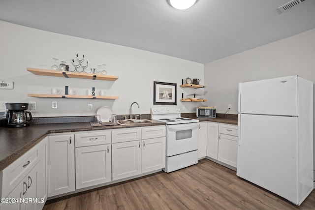 kitchen with hardwood / wood-style flooring, white cabinetry, sink, and white appliances