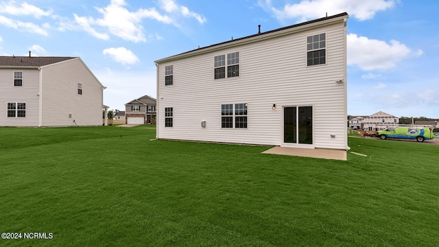 rear view of property featuring a lawn