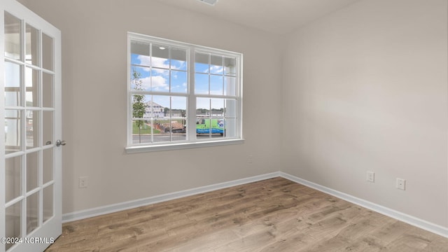 unfurnished room with light hardwood / wood-style flooring