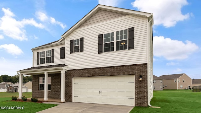 view of front of house featuring a front yard and a garage