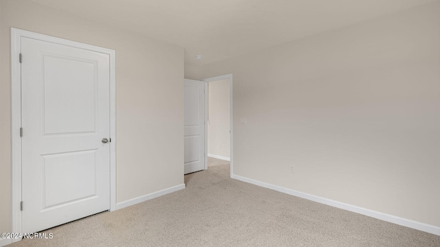 unfurnished bedroom with light colored carpet