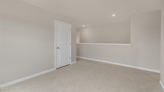 unfurnished room with light colored carpet